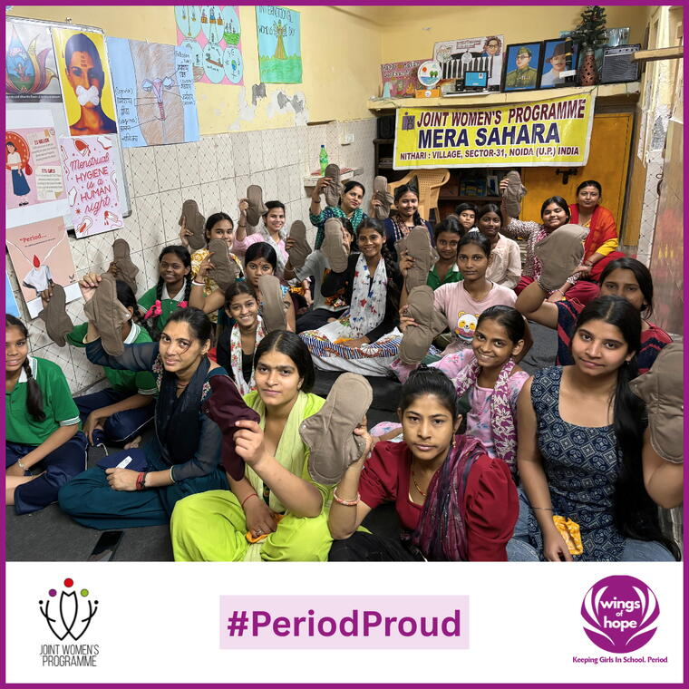 Girls proudly holding reusable cloth pads